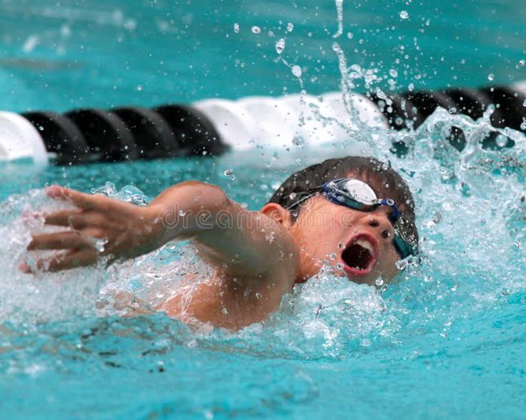 Young swimmer refining freestyle stroke technique during a Dreamers swim lesson