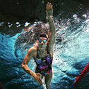 Swimmer in action underwater wearing a colorful swimsuit and goggles - Competitive Swim Training Swimming lessons in Singapore