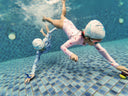 Two children swimming underwater in a pool - Dive underwater and pick up toys during swimming lessons - Dreamers Learn to Swim Program Singapore - Private Condo Swim Lesson