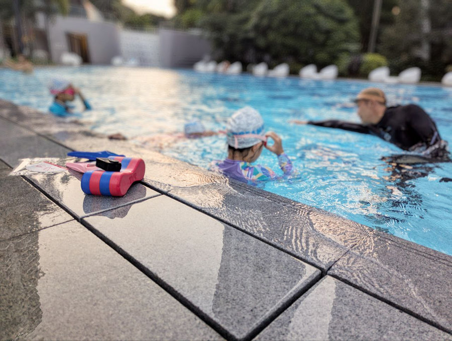 Dreamers coach teaching children in a condominium swimming pool Singapore