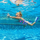 Child swimming underwater in a pool with colorful swim fins - Learn to Swim in Singapore